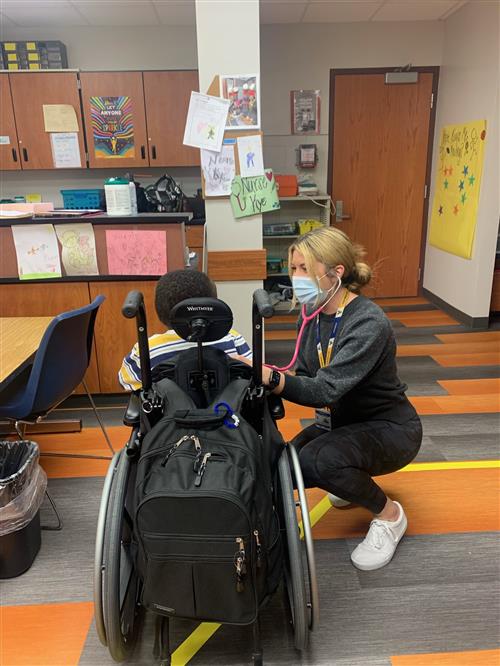 A nurse works with a student