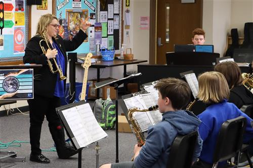 Band teacher works with students