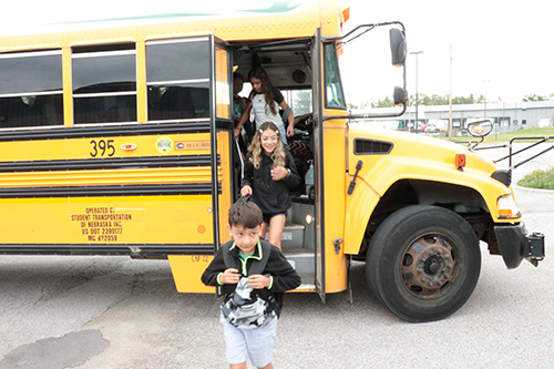 Students exit a bus