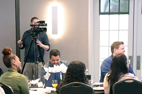 A staff member films an event