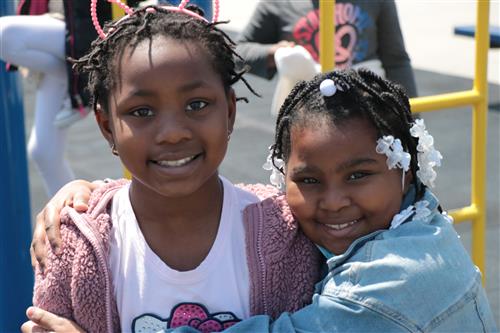 Students smiling and hugging