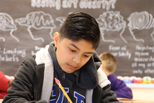 Student working in front of a blackboard