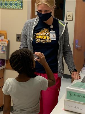 School nurse giving a shtudent a drink