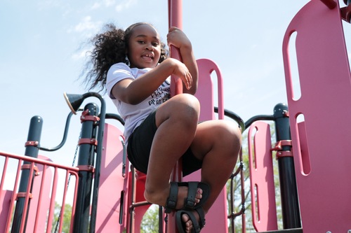 A student plays on a playground