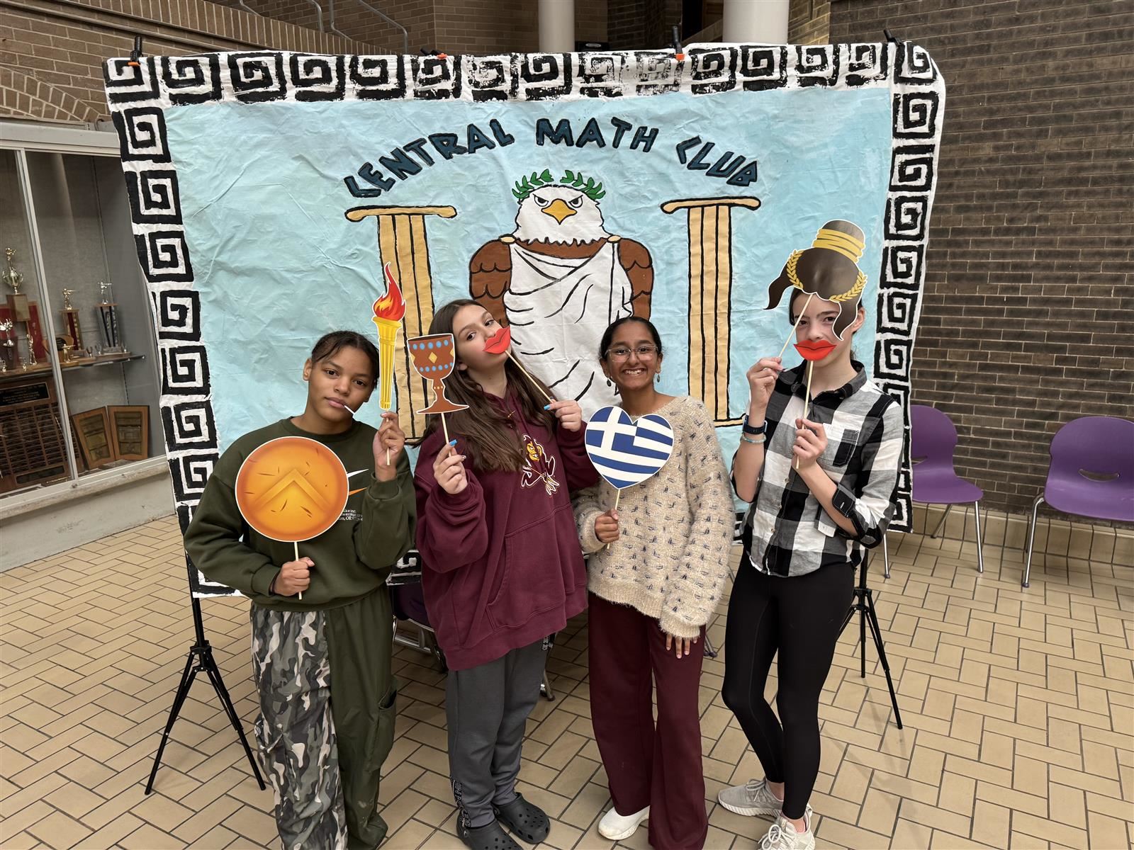  four girls standing in front of a themed math backdrop