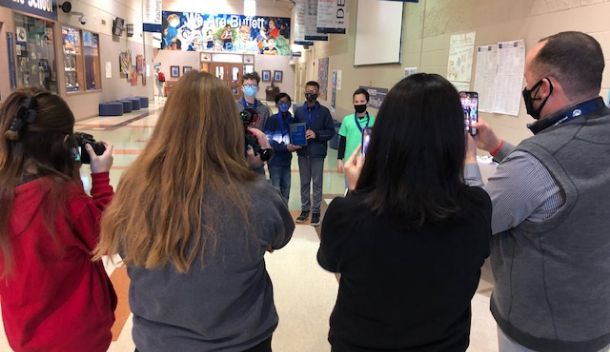  The principal and Journalism students take pictures of the Fermi Math League winners