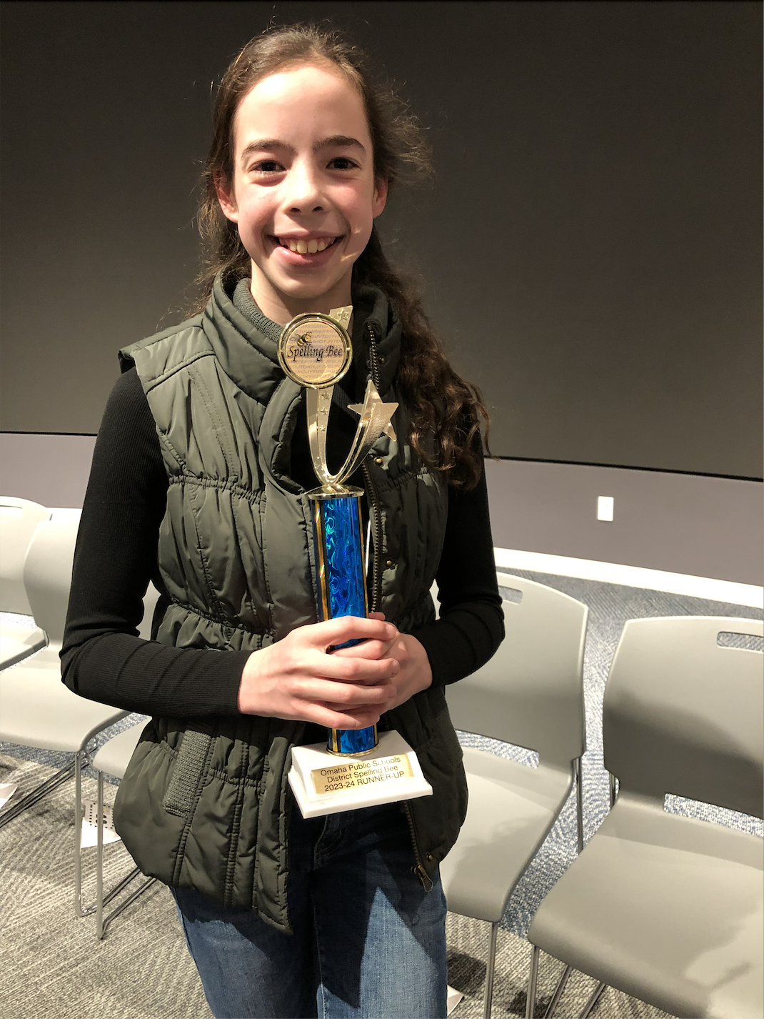  student standing with trophy