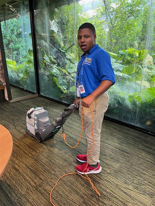 man operating floor cleaner