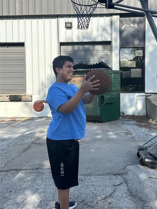 student with basketball