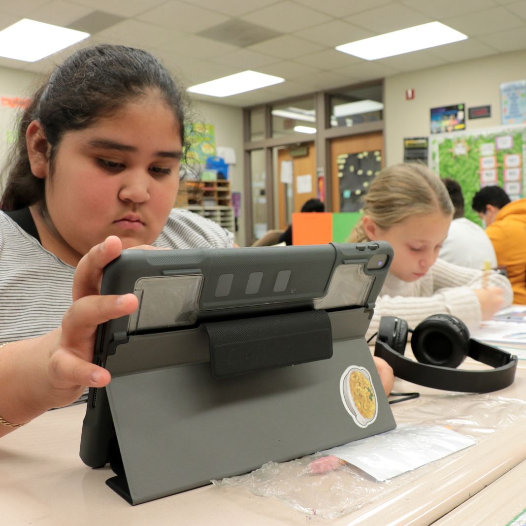  Students working on ipads and paper homework