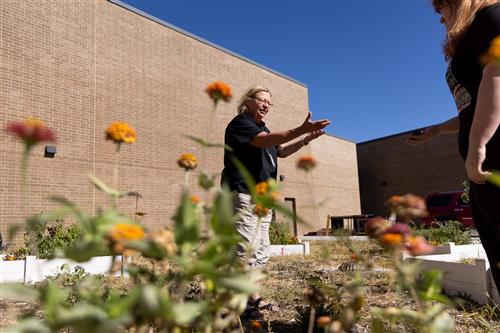 Lee Stover teaches a class outdoors among wildflowers