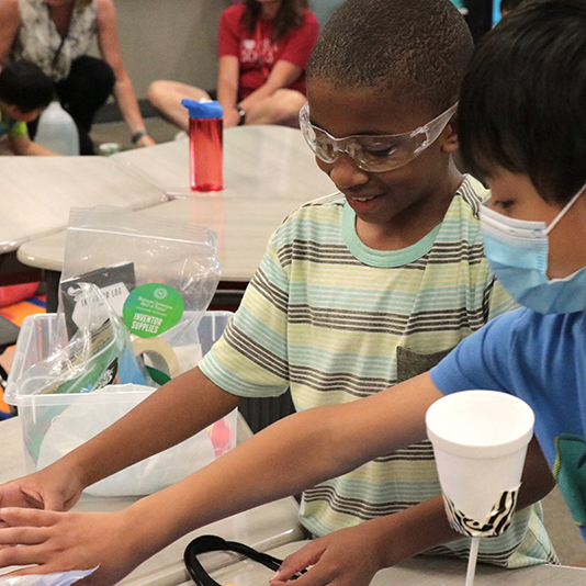  Two students work on a science project