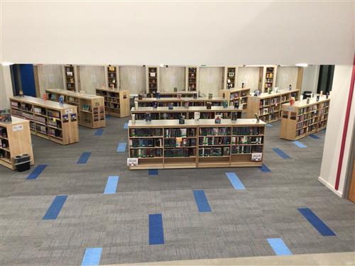 Overview of Library Main Space with shelves of books.