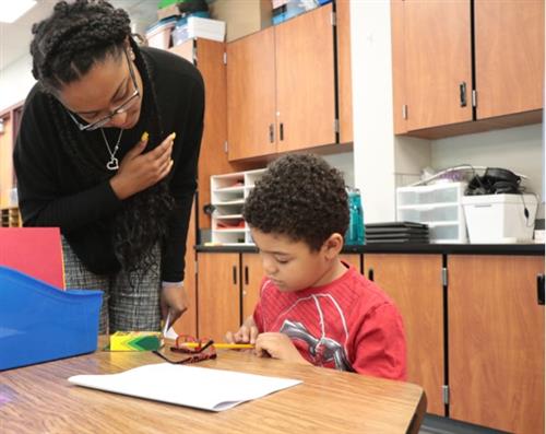 Teacher assisting a student